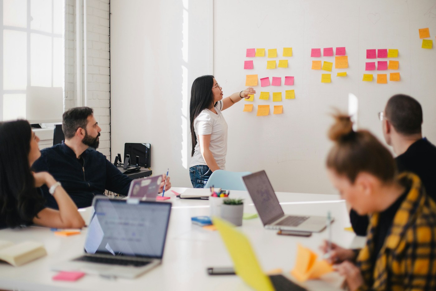 Team discussing a brand strategy with colorful notes on a planning wall